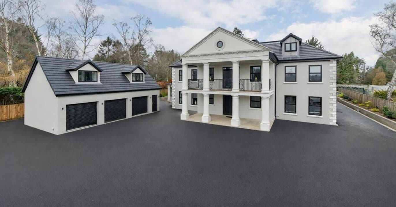 Luxury mansion with detached triple garage and landscaped driveway