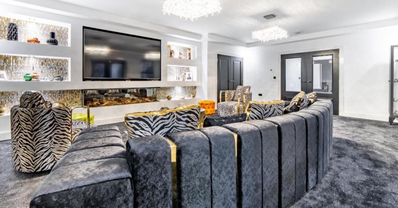 Luxury media room with curved seating and integrated fireplace