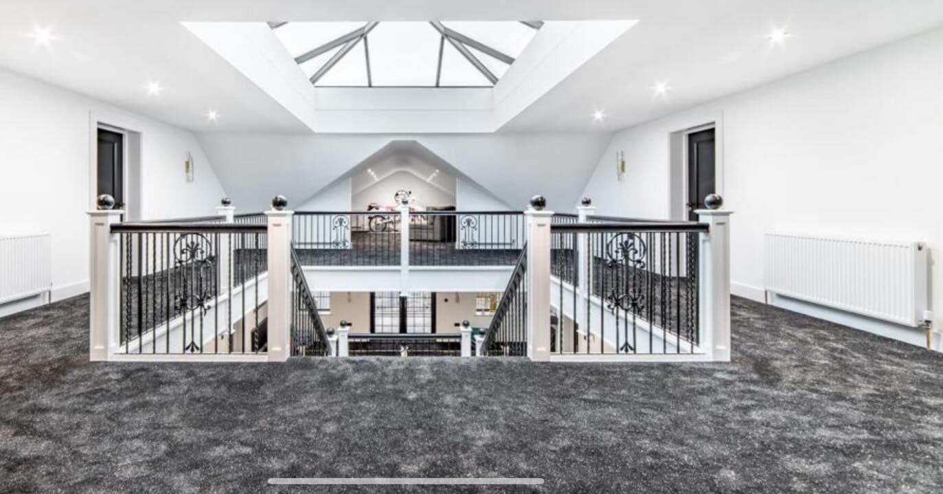 Mezzanine landing with skylight and bespoke metal balustrades